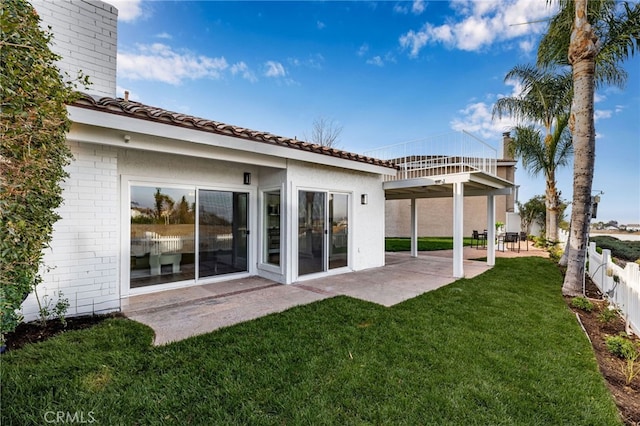 rear view of property with a patio area and a yard