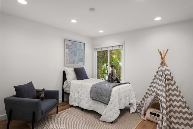 bedroom with hardwood / wood-style flooring