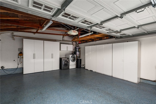 garage with washer and clothes dryer, water heater, and a garage door opener