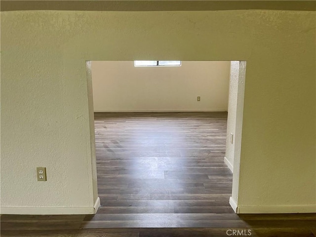 unfurnished room featuring dark hardwood / wood-style flooring