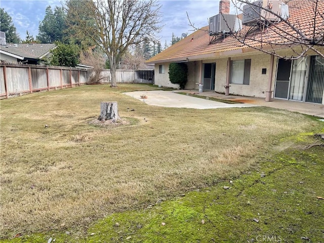 view of yard with central AC and a patio