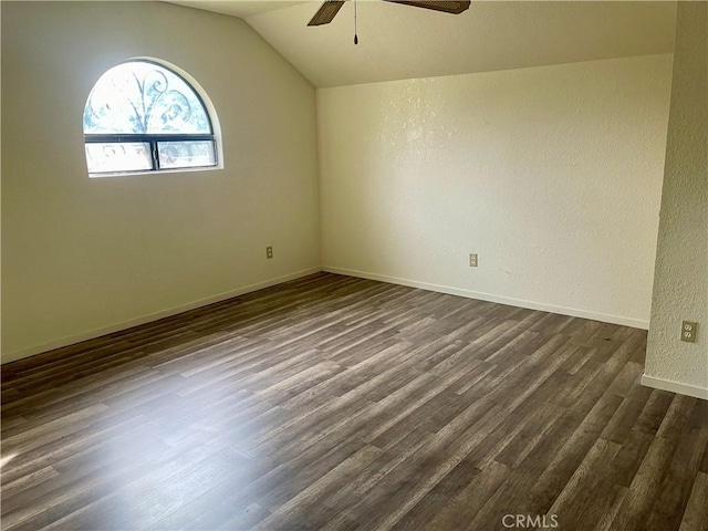 spare room with ceiling fan, dark hardwood / wood-style flooring, and lofted ceiling