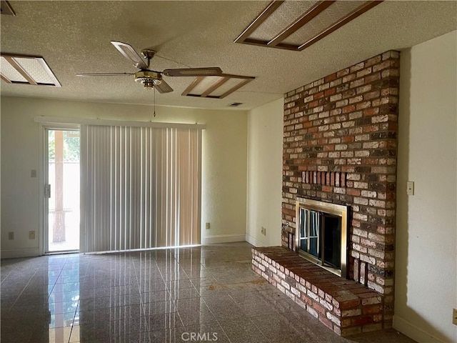 unfurnished living room with ceiling fan, a brick fireplace, and a textured ceiling