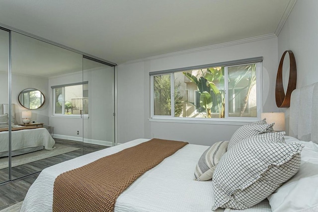 bedroom featuring hardwood / wood-style flooring, crown molding, and a closet