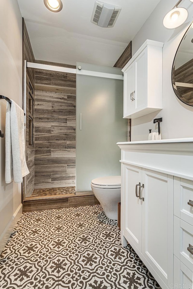 bathroom featuring walk in shower, vanity, and toilet