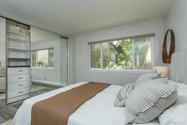 bedroom featuring ornamental molding and dark hardwood / wood-style flooring