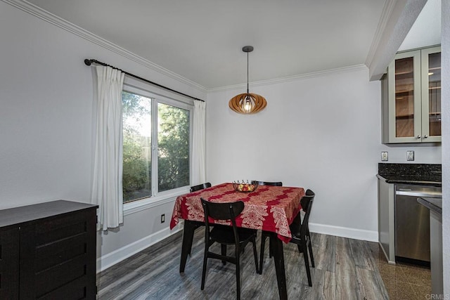 dining space with crown molding and dark hardwood / wood-style flooring