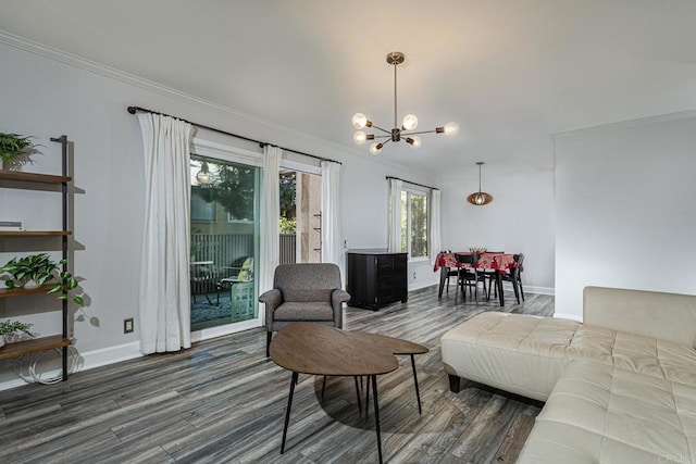 living room with ornamental molding, dark hardwood / wood-style flooring, and a notable chandelier