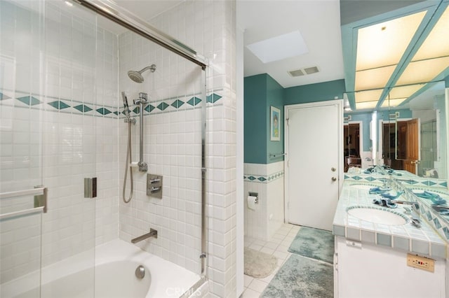 bathroom featuring tile patterned floors, combined bath / shower with glass door, and vanity