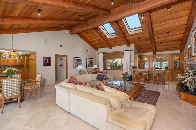 living room featuring high vaulted ceiling, wooden ceiling, a skylight, and beam ceiling