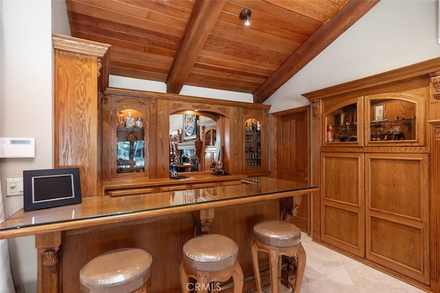 bar with wooden ceiling, lofted ceiling with beams, and light tile patterned flooring