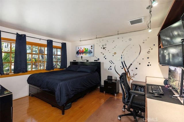 bedroom with hardwood / wood-style floors