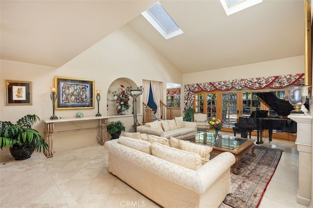 living room featuring high vaulted ceiling and a skylight