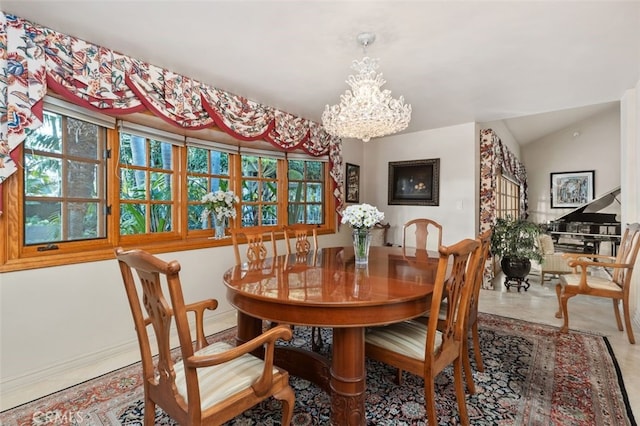 dining space featuring lofted ceiling and a notable chandelier