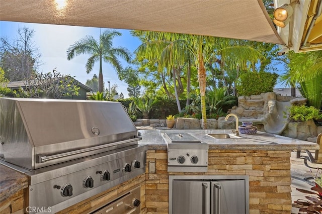 view of patio featuring a grill, an outdoor kitchen, and sink