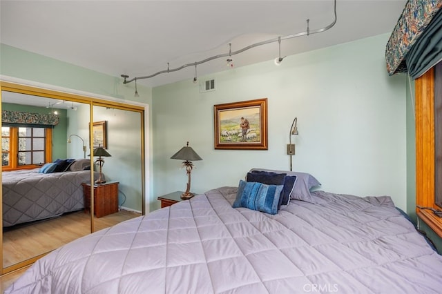 bedroom with a closet and light hardwood / wood-style floors