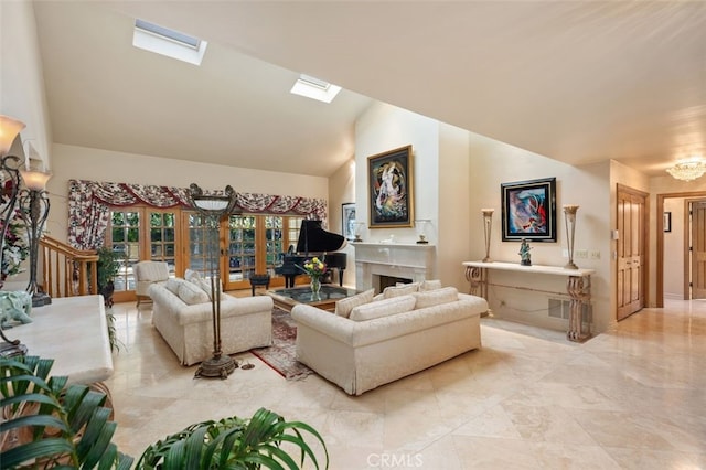 living room featuring vaulted ceiling with skylight and a premium fireplace