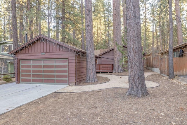 view of front of property with a garage and an outdoor structure