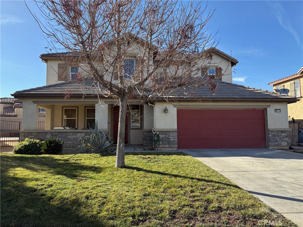 view of front of home with a garage and a front yard