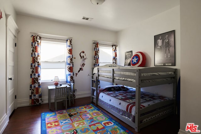 bedroom with dark wood-type flooring