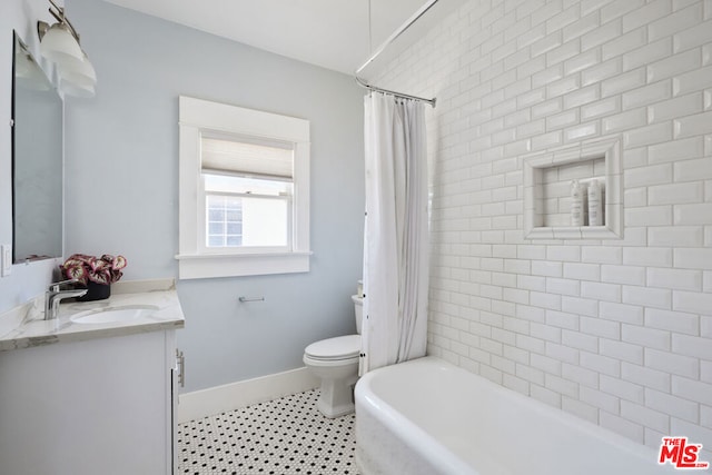 full bathroom with toilet, vanity, and shower / bath combo