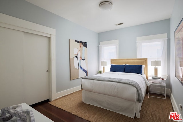 bedroom featuring dark wood-type flooring