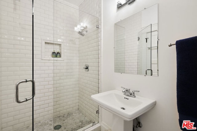 bathroom with walk in shower and sink