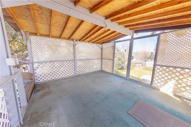 unfurnished sunroom featuring lofted ceiling