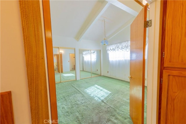 interior space with vaulted ceiling with beams and carpet floors