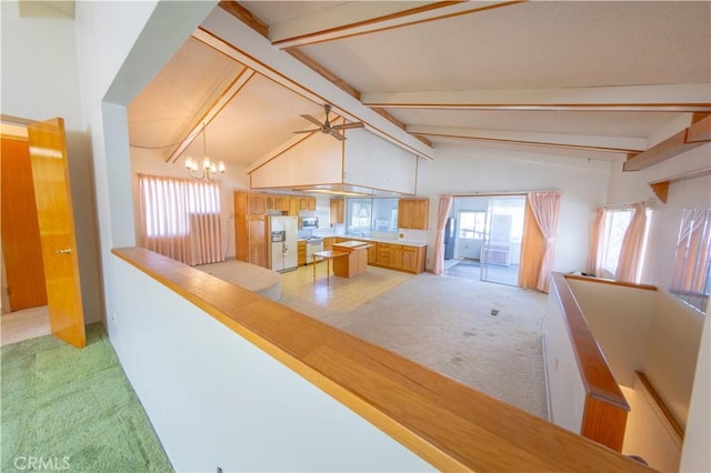 hallway with lofted ceiling with beams, light carpet, and an inviting chandelier