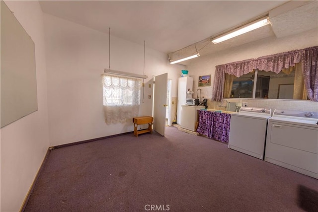 laundry area with dark colored carpet and washer and clothes dryer