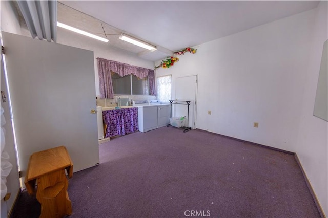 kitchen featuring washing machine and dryer and dark carpet