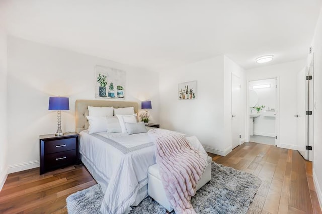 bedroom featuring wood-type flooring and ensuite bathroom