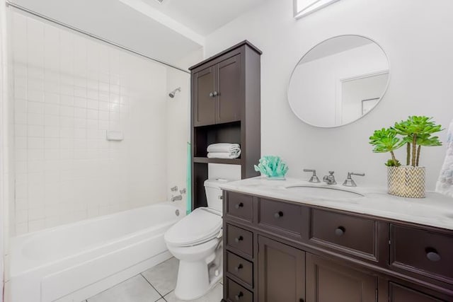 full bathroom with tile patterned flooring, vanity, tiled shower / bath, and toilet