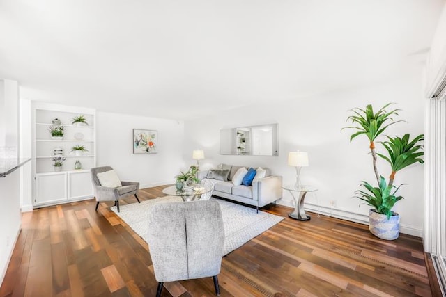 living room featuring dark wood-type flooring and built in shelves