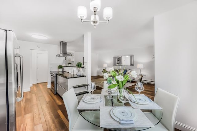 dining area with an inviting chandelier and hardwood / wood-style flooring