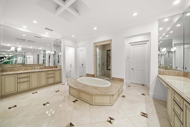 bathroom with tile patterned flooring, a bath, vanity, and an inviting chandelier