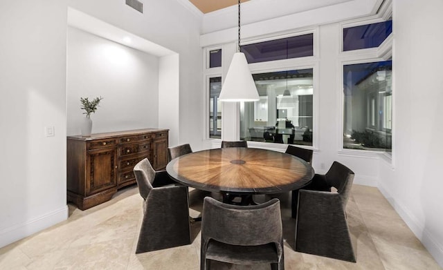 dining space featuring crown molding