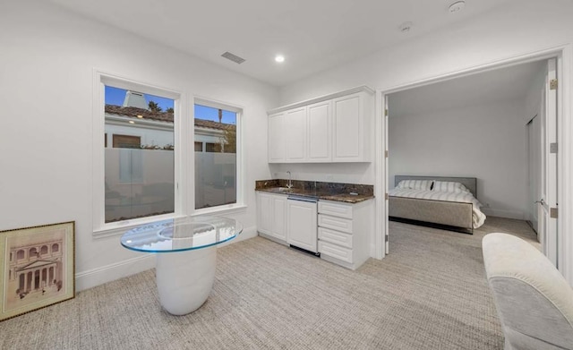 kitchen featuring white cabinets and sink