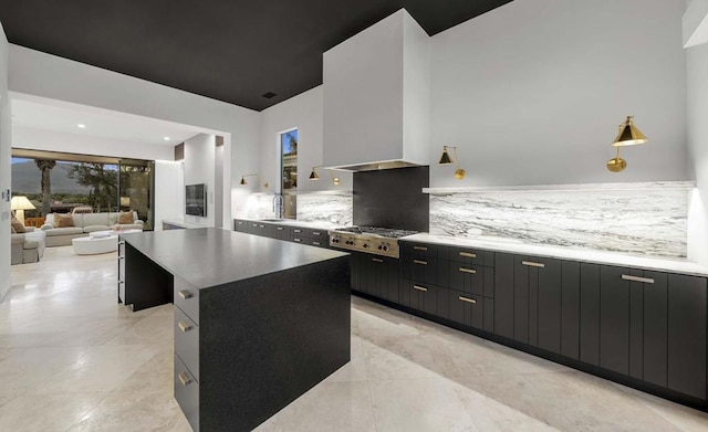 kitchen with stainless steel gas cooktop, backsplash, and a large island