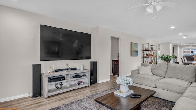 living room with hardwood / wood-style floors and ceiling fan