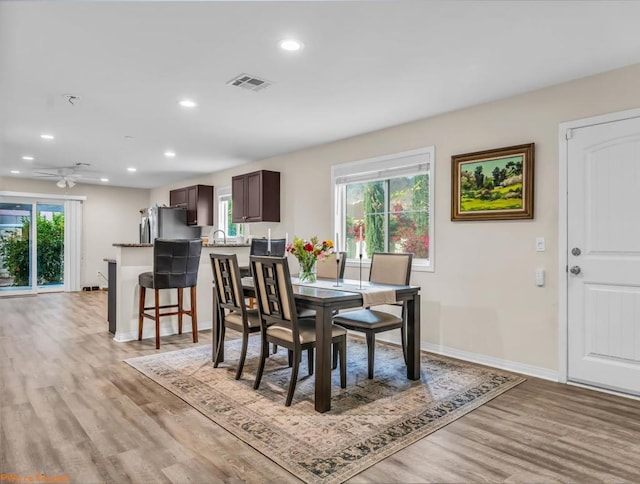 dining room featuring ceiling fan and light wood-type flooring