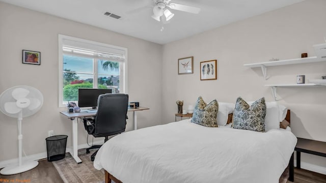 bedroom with wood-type flooring and ceiling fan