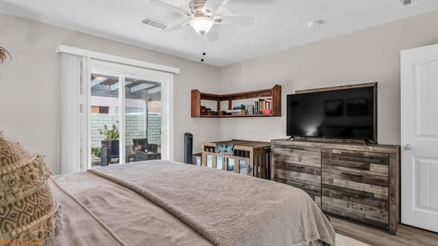 bedroom with access to exterior, ceiling fan, and light hardwood / wood-style floors