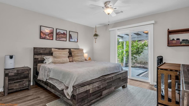 bedroom with ceiling fan, wood-type flooring, and access to outside