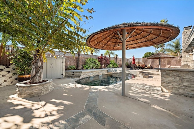 view of patio / terrace with an outdoor kitchen and a fenced in pool