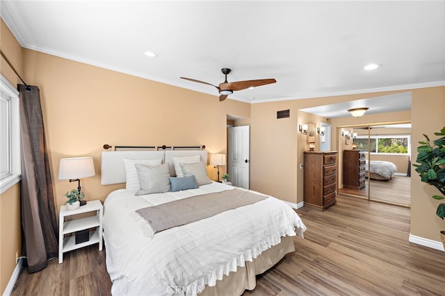 bedroom with ceiling fan, hardwood / wood-style floors, and ornamental molding