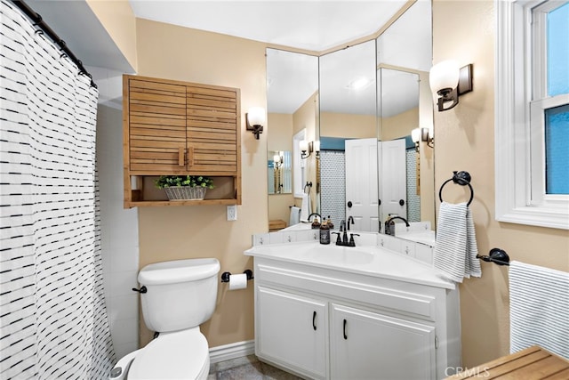 bathroom featuring vanity, a shower with shower curtain, and toilet