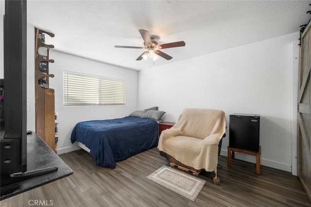 bedroom featuring a textured ceiling, ceiling fan, and hardwood / wood-style flooring