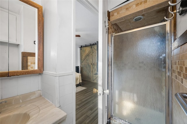 bathroom featuring vanity, a shower with door, and hardwood / wood-style flooring